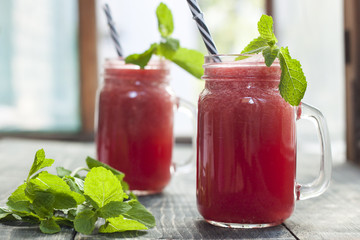 Tasty fresh appetizing watermelon drink smoothie with mint on white table