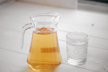 The carafe of juice on a white background
