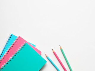 Back to school concept, school supplies, top view of colorful pastel notebooks and pencils on light grey background
