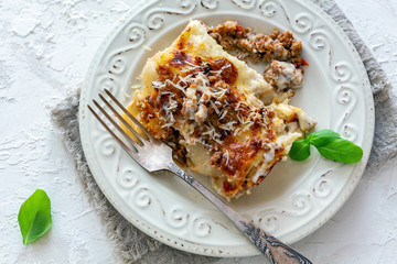 Traditional cannelloni with minced meat, tomatoes and cream sauce.
