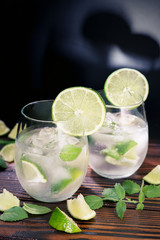 Drink with ice in a glass cup with a slice of lemon