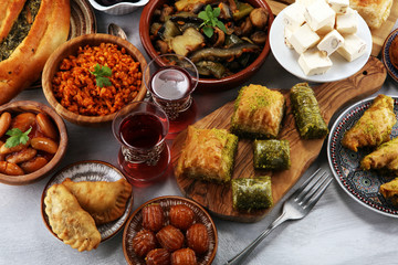 Middle eastern or arabic dishes and assorted meze, concrete rustic background. sambusak. Turkish Dessert Baklava with pistachio. Sarma. Halal food. Lebanese