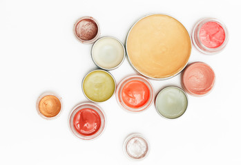 Creamy make up products - top view of decorative cosmetic containers isolated on white backgroiunds