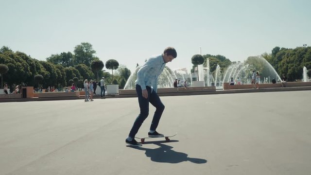 Close up of skater skateboarder man doing 360 kickflip heelflip flip trick in slow motion jump, ollie, city street park young professional man