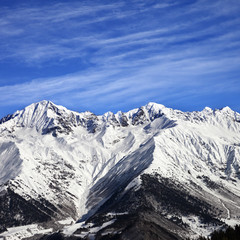 Snowy mountains at sun winter day