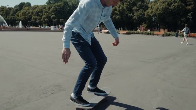 Close up of skater skateboarder man doing 360 kickflip heelflip flip trick in slow motion jump, ollie, city street park young professional man