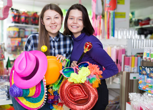 Girls joking in festive accessories shop