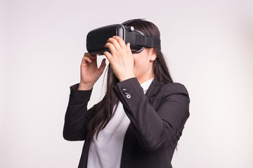 Young woman with virtual reality helmet on white background
