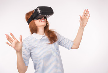 Young redhead woman using glasses of virtual reality