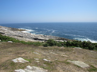 View at Pemaquid Point Lighthouse in Maine of the rocky coastline 