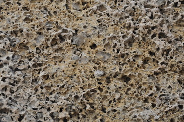 Background texture porous stone wall closeup