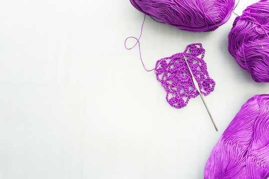 Crochet Hook and Wool. Crochet hook and lilac wool.