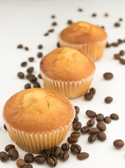 aerated cupcakes isolated on white background. excellent breakfast. fresh bakery. with scattered coffee beans.