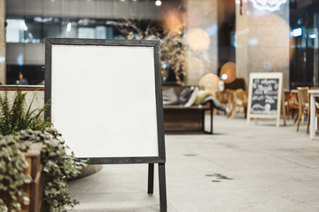 Close up of sandwich board at the street next to restaurant.