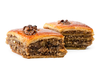 Two pieces of baklava with nuts close-up. Isolated on a white.