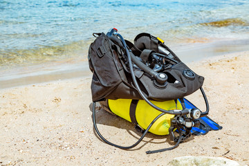 Equipment of a scuba diver, an oxygen balloon lies on the beach. Diving, equipment, fins, balloons,...