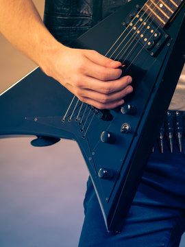 Male hands playing electric guitar