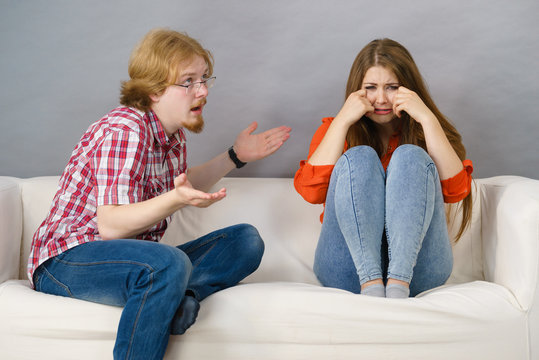 Woman and man after argue on sofa