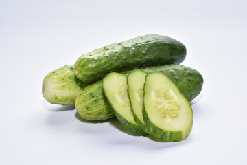 green cucumbers gherkins, fresh from the garden, on a white background