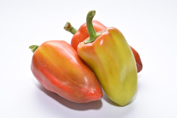 red and yellow sweet bell peppers on a white background, vegetable assortment