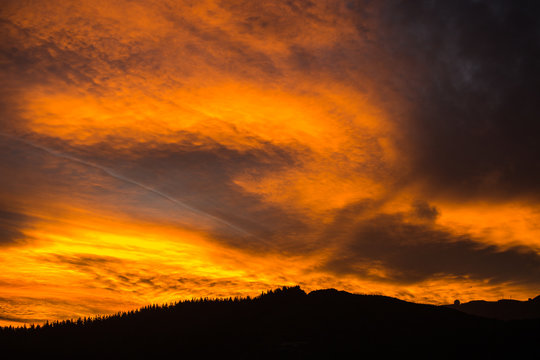 Epic fiery sunset above the tree line 2