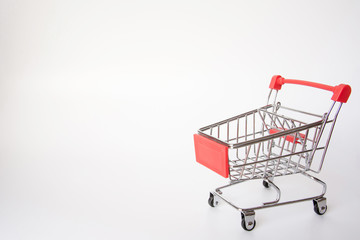 Red Shopping cart or supermarket cart on white background with copy space
