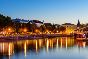 Fototapeta premium Cityscape of Tartu at night. The historical city center and the Emajogi river in the night, Tartu city, Estonia