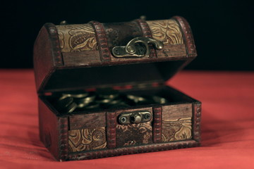 chest with coins on a black and red background