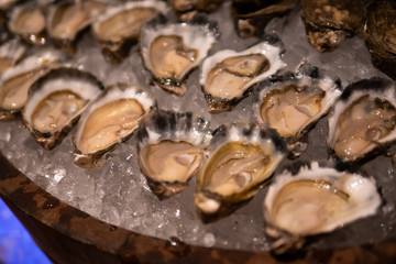 Fresh oysters close-up on ice. Raw oysters are packed with nutrition, high in calcium, potassium, magnesium, vitamin and mineral. Flavor are sweet and refreshing. Believed to be an aphrodisiac.