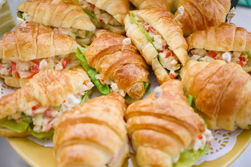 Tasty Croissant Sandwich stuffed with Potato salad and green lettuce. Simple yet delicious and packed with nutrition. Perfect menu for vegetarian and party canape. Healthy eating and eat well concept.