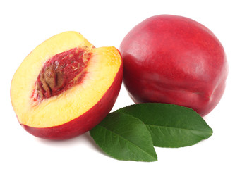 Nectarine with green leaf and slices isolated on white background.