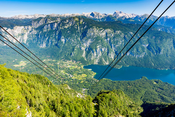 Aerial view of Bohinj lake from Vogel cable car station. Mountains of Slovenia in Triglav national park. Julian alps landscape. Blue water, summer sky, mountains in the bakcground
