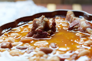 Delicious Beans with smoked pork on plate