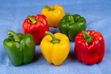 Colored paprika (pepper)  on blue fabric