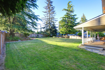 Spacious back yard with neatly cut grass.