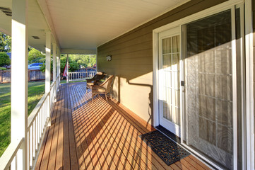 Wrap around porch with view of the back yard.