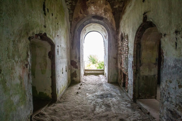 Abandoned building. Corridors in the old building. Shabby walls. Round doorways.
