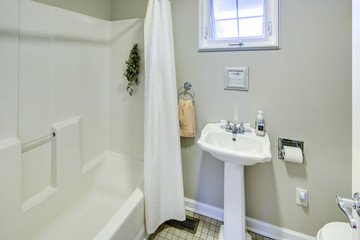 Fototapeta na wymiar Rustic bathroom with white pedestal sink.
