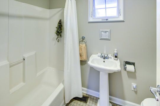 Rustic bathroom with white pedestal sink.