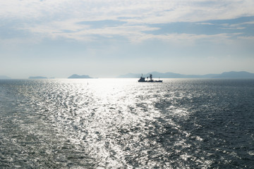 Ship in backlight in front of Jindo islands at a sunny day, South Korea