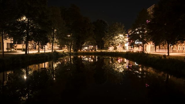 Time lapse of big city at night with a lake in Germany, Oldenburg