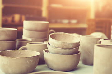 handmade unbacked crockery on the table, potter's studio, ceramic making process