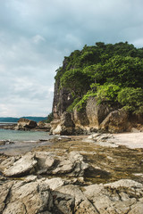The rocky beach shore of Playa Cuevas in between Santa Teresa and Malpaís on the Nicoya peninsula of Costa Rica