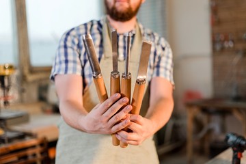 Carpenter holding carpentry tools in the carpentry shop close-up
