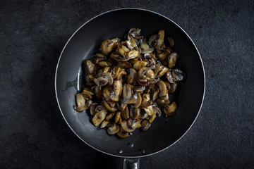Preparing mashrooms in the pan,selective focus