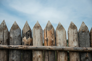 Fototapeta premium Reconstructed palisade of wood in the Museum. Ancient designs