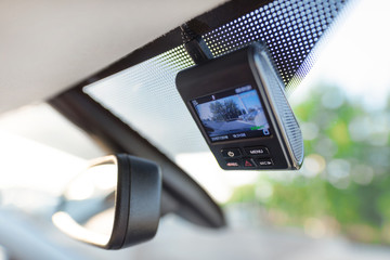 Video recorder next to a rear view mirror