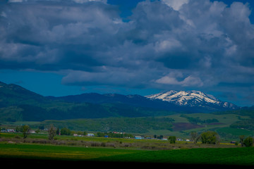 Beautiful outdoor view of lamar valley in Yellowstone National Park, Wyoming in summer with a mountain behind, partial covered with snow