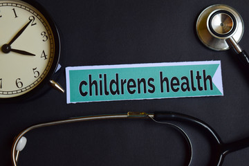 Childrens Health on the print paper with Healthcare Concept Inspiration. alarm clock, Black stethoscope.