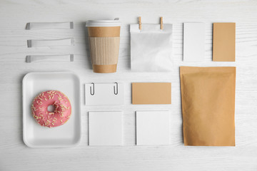 Flat lay composition with items for mock up design on wooden background. Food delivery service